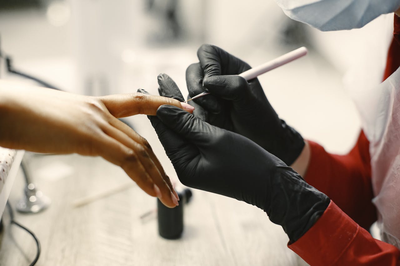Home Close-up of a professional manicure session with tools and black gloves in a modern salon.